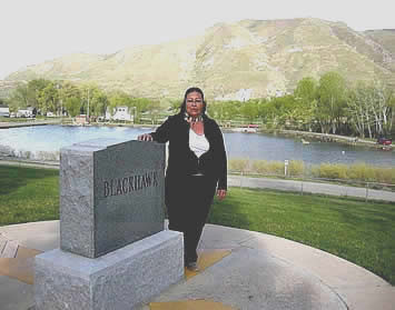 Executive Chief of the Timpanogos Nation standing at the headstone of Timpanogos Chief Black Hawk in Spring Lake, Utah.