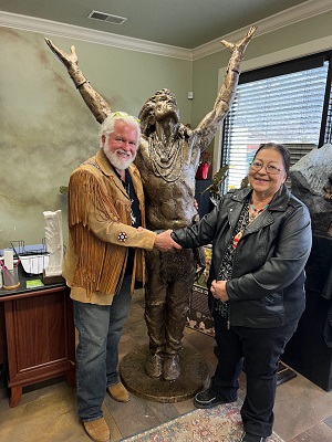 Sculptor Gary Lee Price with Timpanogos Chief Executive Mary Murdock Meyer. Bronze sculpture of Timpanogos Chief Wakara in background. 